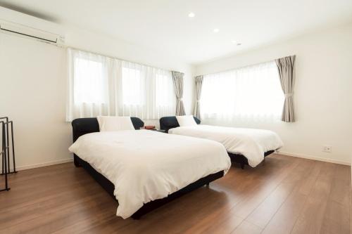 Un pat sau paturi într-o cameră la スターレジデント