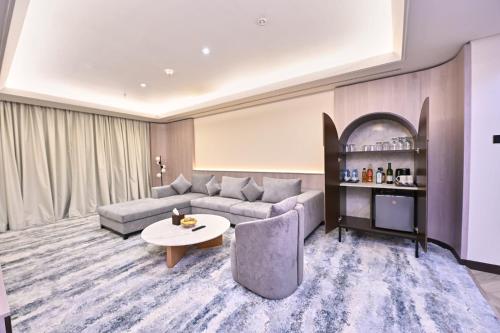 a living room with a couch and a table at Pavilion Palace Hotel in Dubai