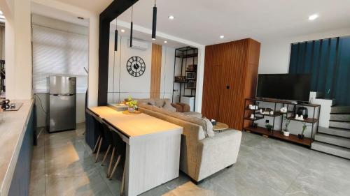 a living room with a couch and a table at Villa Dalia Puncak NA6-12 in Cimacan