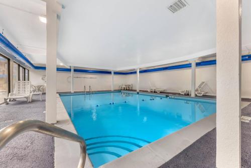 a large pool with blue water in a building at Rodeway Inn Lyons - La Grange in Lyons