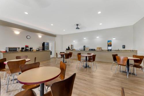 a room with tables and chairs and a counter at Rodeway Inn Lyons - La Grange in Lyons