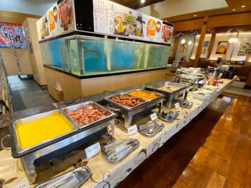 a buffet line with many different types of food at Comfort Inn Kagoshima Taniyama in Kagoshima