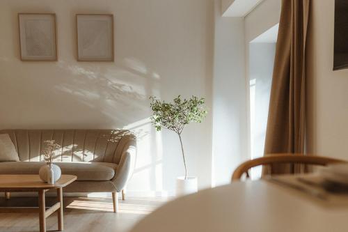 a living room with a couch and a table at Studio&Stay Room in Ghent