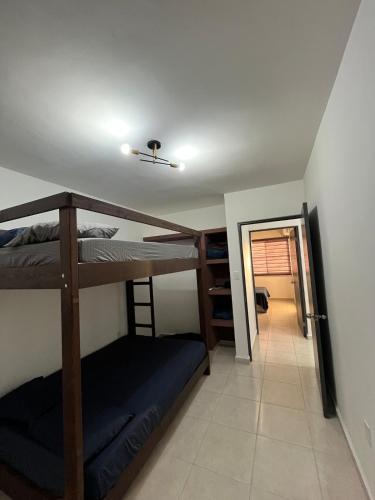 a room with two bunk beds and a hallway at Noir Beach Suite in Ciudad Madero