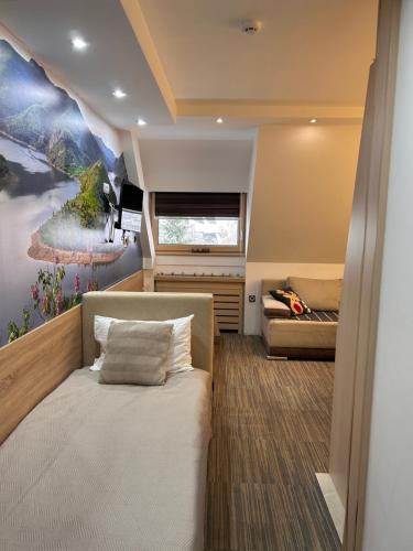 a bedroom with a bed and a large window at Tri-M Konaci in Kopaonik