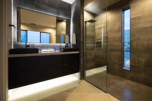 a bathroom with two sinks and a mirror at The Coza by Fieldtrip - Modern Retreat w Pool Spa in Joshua Tree