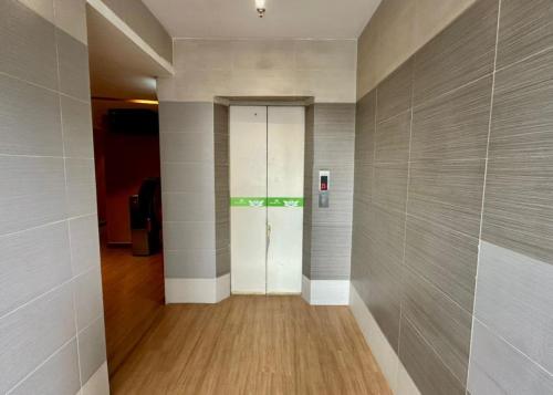 a hallway with a door in a building at Swing & Pillows - Chow Kit Road, Kuala Lumpur in Kuala Lumpur