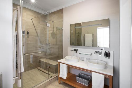 a bathroom with two sinks and a shower at Studio Stay on Sixty6 in Johannesburg