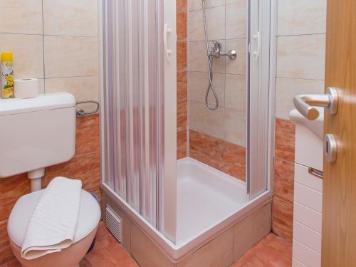 a bathroom with a shower with a white toilet at Villa Valentina in Zadar