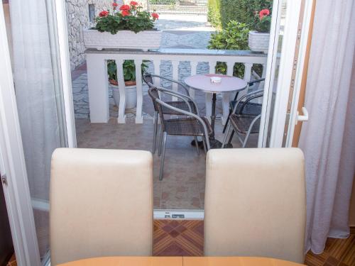 a small balcony with a table and chairs on a porch at Villa Valentina in Zadar