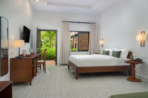 Ένα ή περισσότερα κρεβάτια σε δωμάτιο στο Green Morodoc Garden Hotel