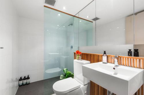 a bathroom with a sink and a toilet and a shower at Drews Bondi Beach Pad Music Inspired in Sydney