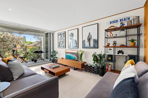 a living room with a couch and a table at Drews Bondi Beach Pad Music Inspired in Sydney