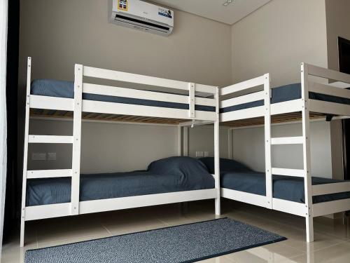 two bunk beds in a room with at Beiruty House -Elegant Family Seaside Villa in As Sīfah