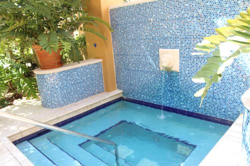 a swimming pool with a blue tiled wall and a blue tiled shower at Yacht Club at Aventura Luxurious 1 Bed 1 Bath in Aventura
