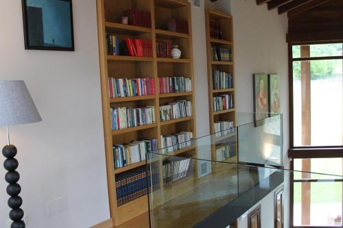 a glass counter in front of a book shelf at La QuintaEsencia in La Pereda de Llanes