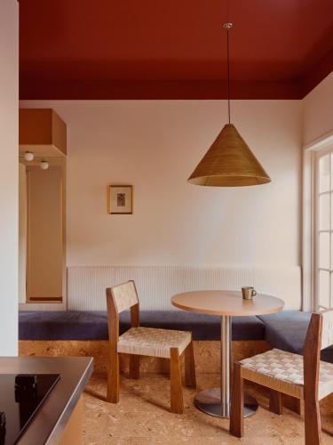 a dining room with a table and chairs at Halse Lodge Noosa Heads in Noosa Heads
