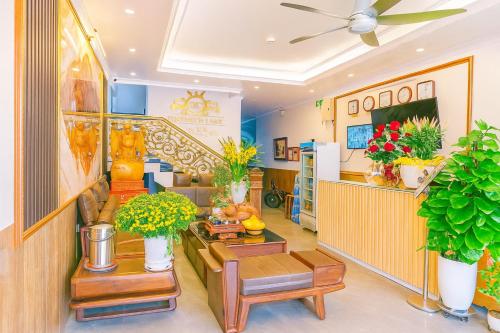 a living room with potted plants and a staircase at Hoàng Gia Hotel Royal in Kim Bảng