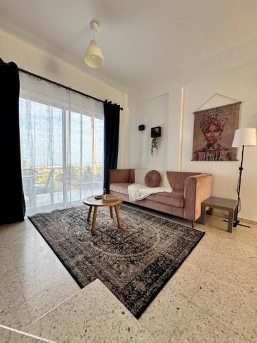 a living room with a couch and a table at Two Bedroom Sea View Townhouse-Villa Libellula in Chlorakas