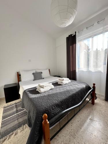 a bedroom with a large bed with towels on it at Two Bedroom Sea View Townhouse-Villa Libellula in Khlorakas