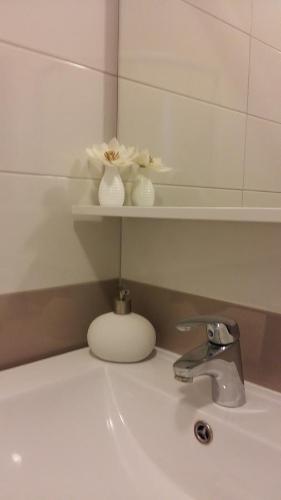 a bathroom sink with a mirror next to a sink at Apartment Adriatic in Umag