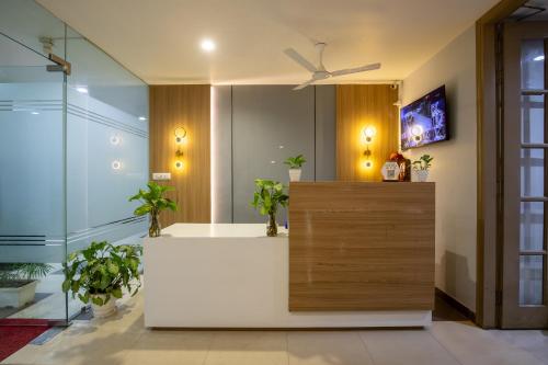 a bathroom with a white counter with potted plants at BedChambers Serviced Apartment, Medicity in Gurgaon