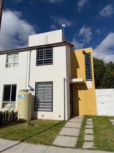 a white house with black shutters on it at Cozy House with Private Garden in Pachuca in Pachuca de Soto