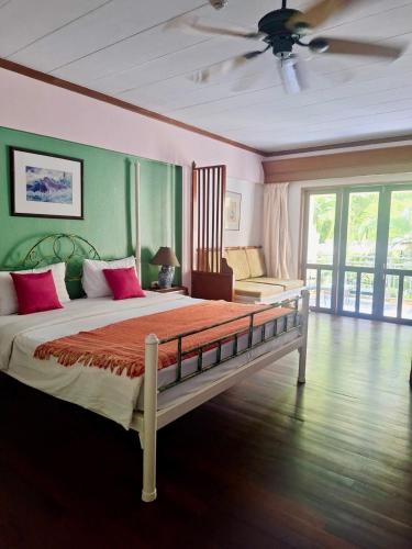 a bedroom with a large bed and a ceiling fan at Successive BeachFront ,Krabi in Ban Khlong Haeng