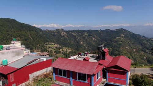 a red house sitting on top of a mountain at Namaste Home Stay in Dhulikhel