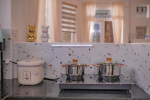 two pots sitting on a stove in a kitchen at BB House Villa in Da Thanh