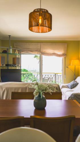 a living room with a table and a bedroom at SeaHomes Vacations - NAUTIC MARITIME Apt in Blanes