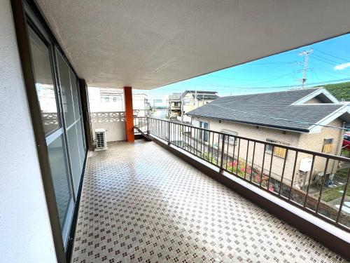 a balcony with a view of a house at 徳之島体験お宿結屋 in Tokunoshima