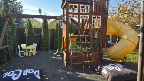a playground with a slide and a play structure at Casa Rosa by MANAGR in Piatra Neamţ