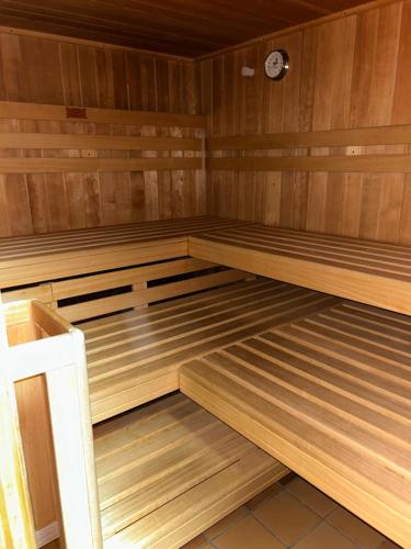an empty sauna with wooden floors and a clock at Ferienhaus Albmatte-Naturidyll am Fluss-Novemberaktion-Sauna inklusive in St. Blasien