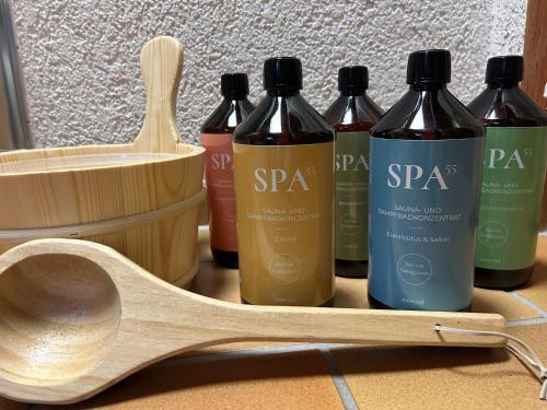 a wooden spoon and four bottles of sauce at Ferienhaus Albmatte-Naturidyll am Fluss-Novemberaktion-Sauna inklusive in St. Blasien