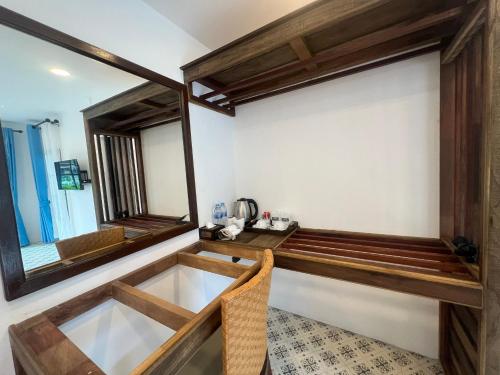 a room with a mirror and a table at Baan Purada in Ko Lanta
