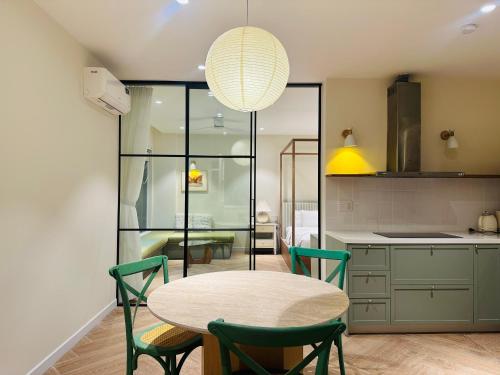 a kitchen with a table and chairs in a room at Sip Boutique Villa & Apartment in Hoi An