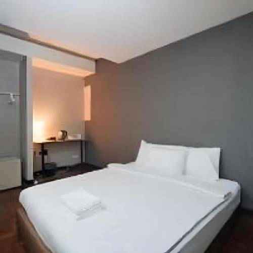 a large white bed in a small room at BOB INN Silom - BTS Surasak in Yan Nawa