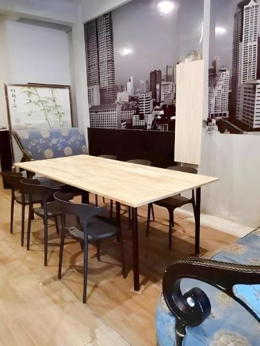 a table and chairs in a room with a city at xx GO INN Silom - BTS Surasak Pro in Yan Nawa
