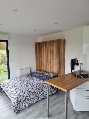 a bedroom with a bed with a wooden headboard at Le bêêêl endroit in Gélucourt