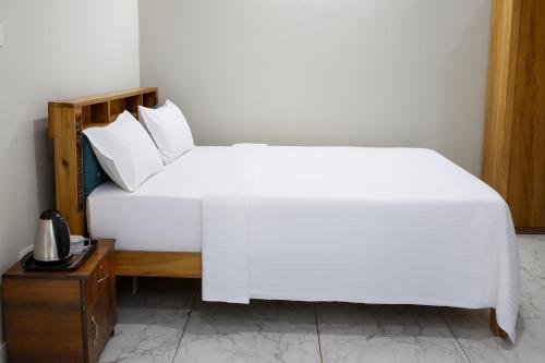 En eller flere senge i et værelse på Rk Resorts