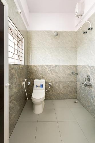 a bathroom with a toilet and a shower at Rk Resorts in Bangalore