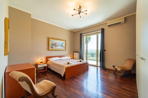 a bedroom with a bed and a table and chairs at Villa with Pool in Unesco, 4 Room, Parking e Free WiFi in San Damiano dʼAsti