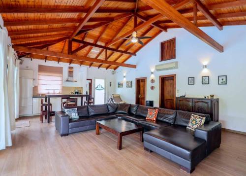 a living room with a couch and a table at Gin Villa in Kammala South