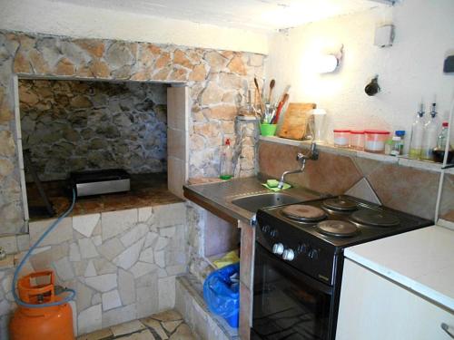 a small kitchen with a stove and a sink at Studio Slatine 12811a in Slatine