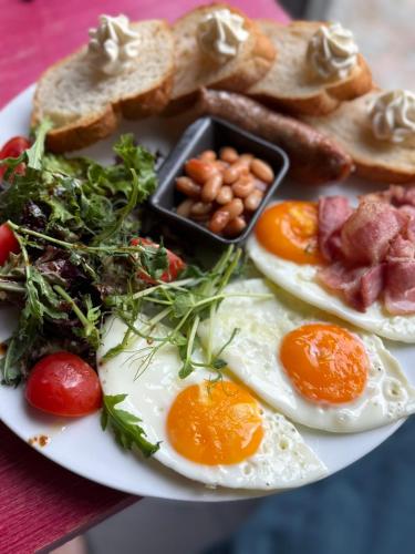 a plate of eggs and toast and other foods at Красник Хілс in Krasnik