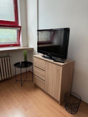 a flat screen tv sitting on top of a wooden cabinet at Apartmán v centre Dubnice nad Váhom in Dubnica nad Váhom