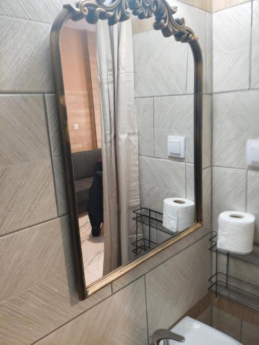 a mirror in a bathroom with a sink and towels at Gcm 3 rooms kentro κατερινη in Katerini