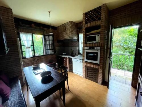 a kitchen with a table with a cat sitting on it at Spacious Villa with Pool in Cabeanca 250 m² in Ourense
