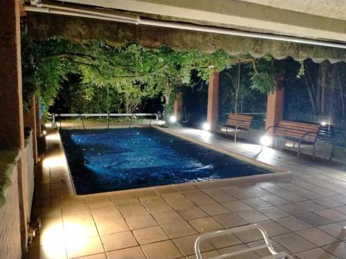 a swimming pool with lights in a building at Spacious Villa with Pool in Cabeanca 250 m² in Ourense